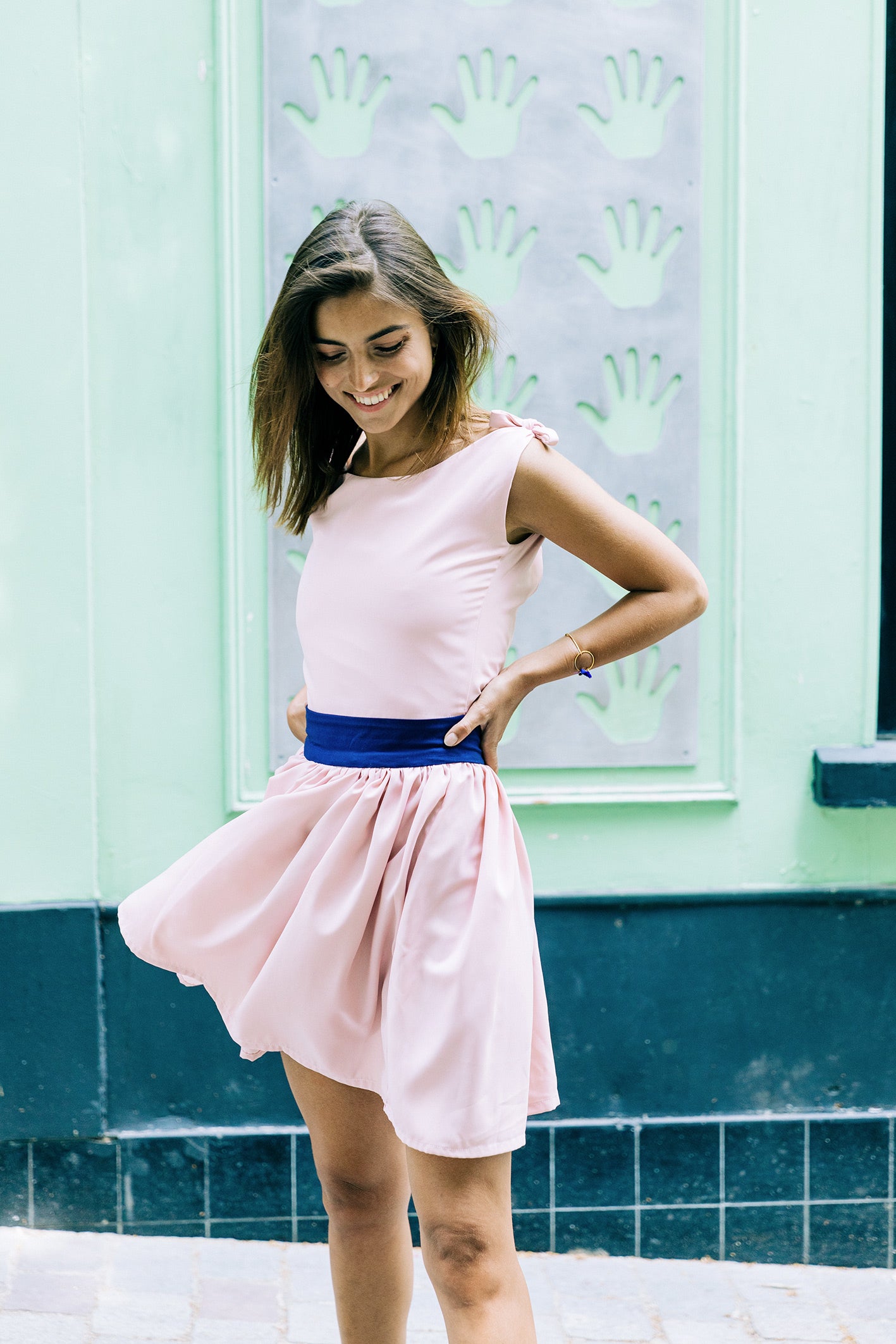 Robe 'Clarisse' en soie rose pastel avec bretelles à nouer, vue complète en mouvement avec détail du tissu.